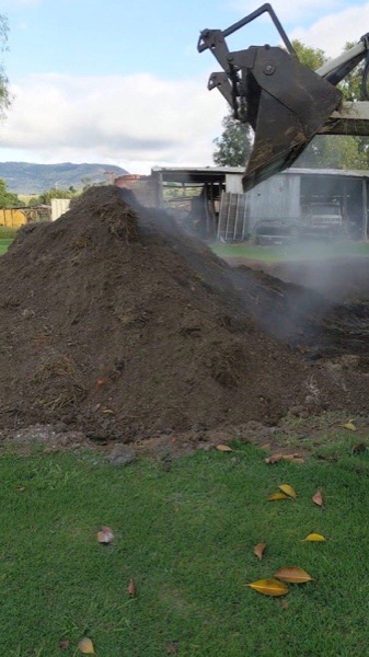 A heap of screened topsoil steaming in the morning air