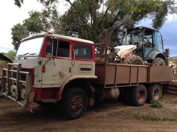 The tip truck loaded with the backhoe, ready to float to the next job