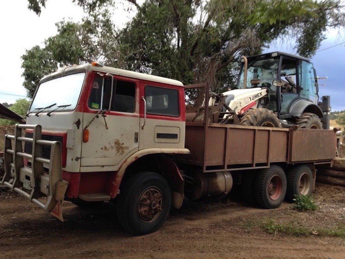 The tip truck loaded with the backhoe, ready to float to the next job